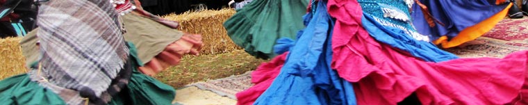 circle of dancers. Their colorful skirts are swirling as they dance.