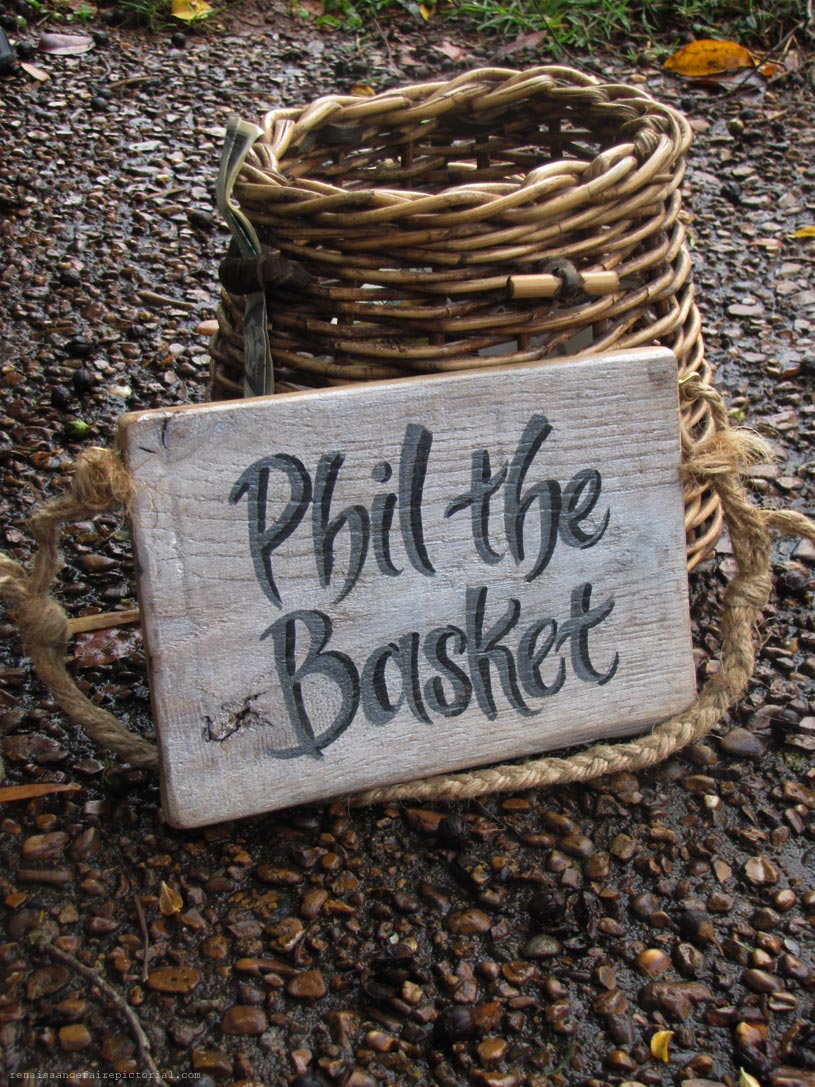 wicker Tip Jar with sign that reads phil the basket. Phil is spelled P H I L like the man's name.